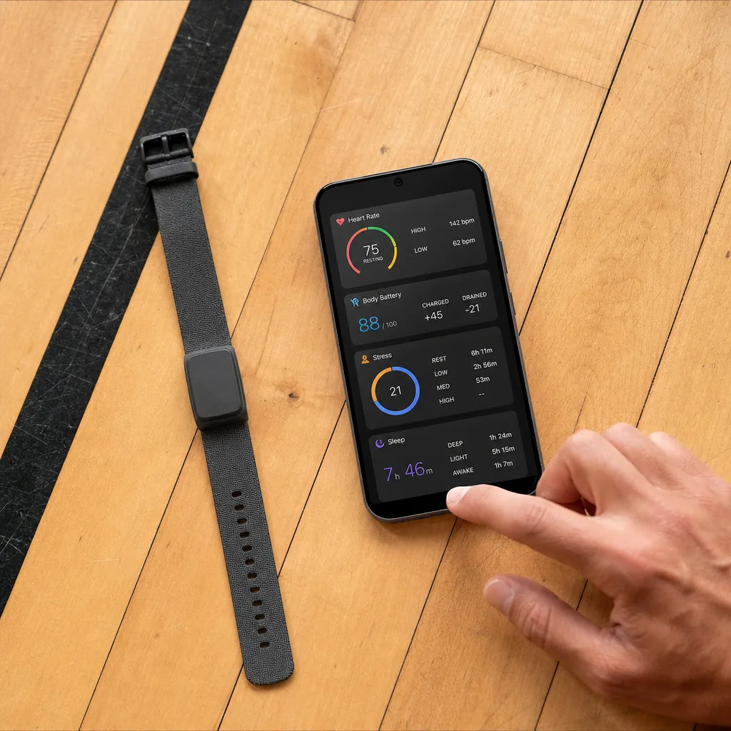 A slim screenless fitness tracker band in mauve on a concrete surface