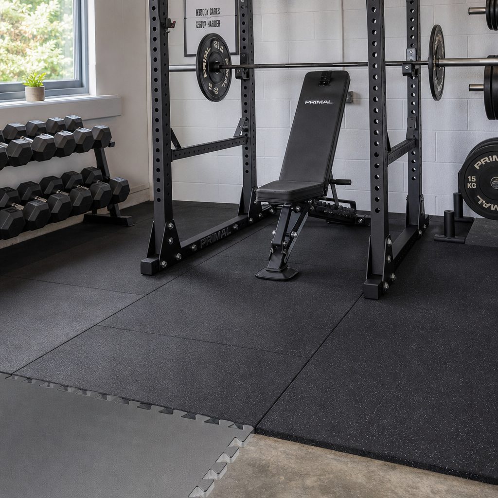 Dense rubber is the calmer long-term choice beneath fixed equipment. Once a rack, bench or machine has a permanent home, the floor beneath it stops being a temporary exercise surface.